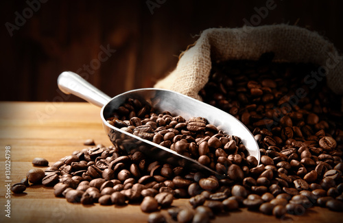 Coffee beans with scoop on table