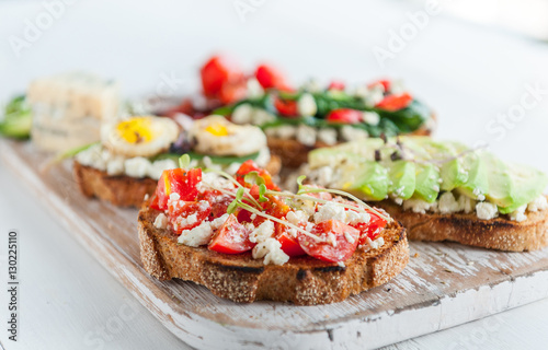 tasty and delicious bruschetta with with vegetables, cheese and micro greens