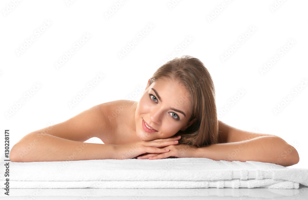 Beautiful young woman lying on towel on white background Beautiful young woman lying on towel on white background