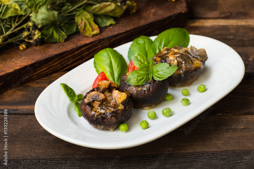 Stuffed champignon quail eggs with basil and tomatoes. Wooden background. Close-up Stuffed champignon quail eggs with basil and tomatoes. Wooden background. Close-up