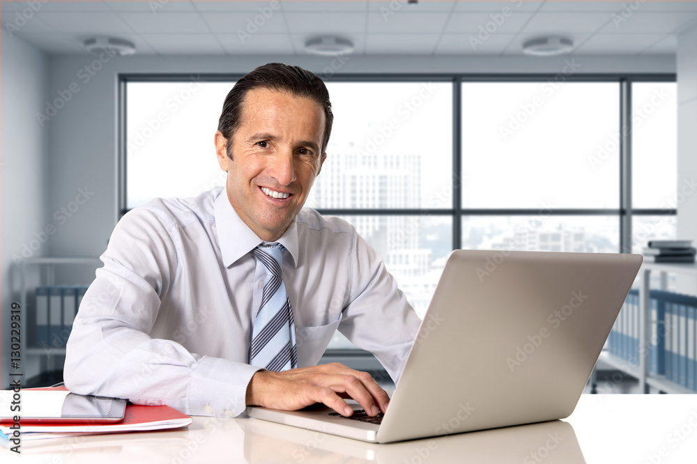 businessman working on computer laptop sitting at desk looking confident businessman working on computer laptop sitting at desk looking confident