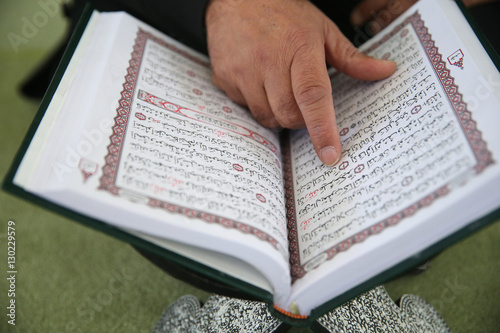 Man reading the Quran in a mosque, Bussy-Saint-Georges, Seine-et-Marne, France photo