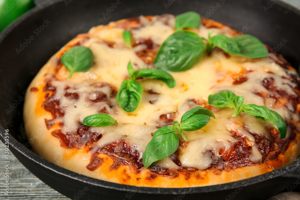 Freshly baked pizza in a pan Freshly baked pizza in a pan