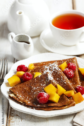 Crepes with fresh mango and raspberries