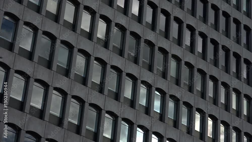 corporate building timelapse: clouds moving over the windows of the building 