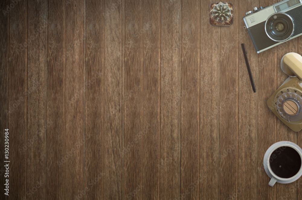 Office desk table with computer, supplies, coffee cup and flower on wood background.Top view with copy space. Office desk table with computer, supplies, coffee cup and flower on wood background.Top view with copy space.
