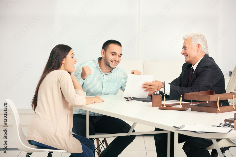Young couple with notary at office Young couple with notary at office