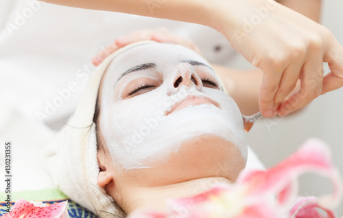 Facial mask.Beautiful young girl relaxing at spa ,getting skin treatment