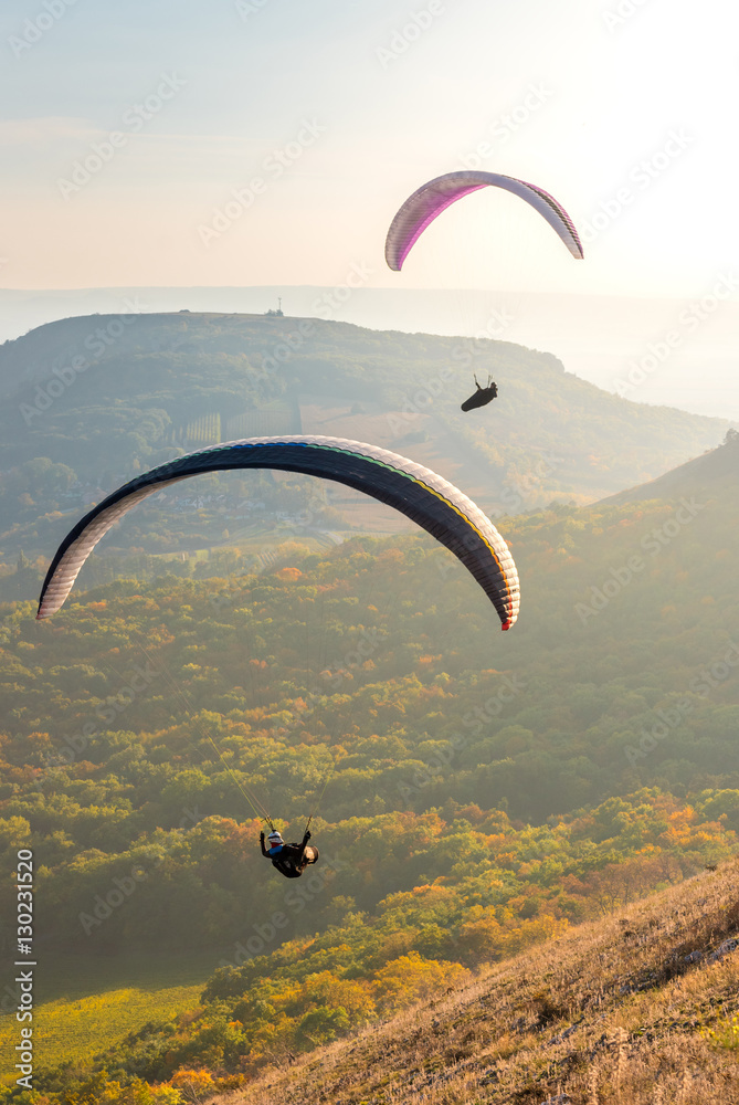 Paragliders in sunny day flying in Palava, hill Devin, South Moravia, Czech Republic - obrazy, fototapety, plakaty 