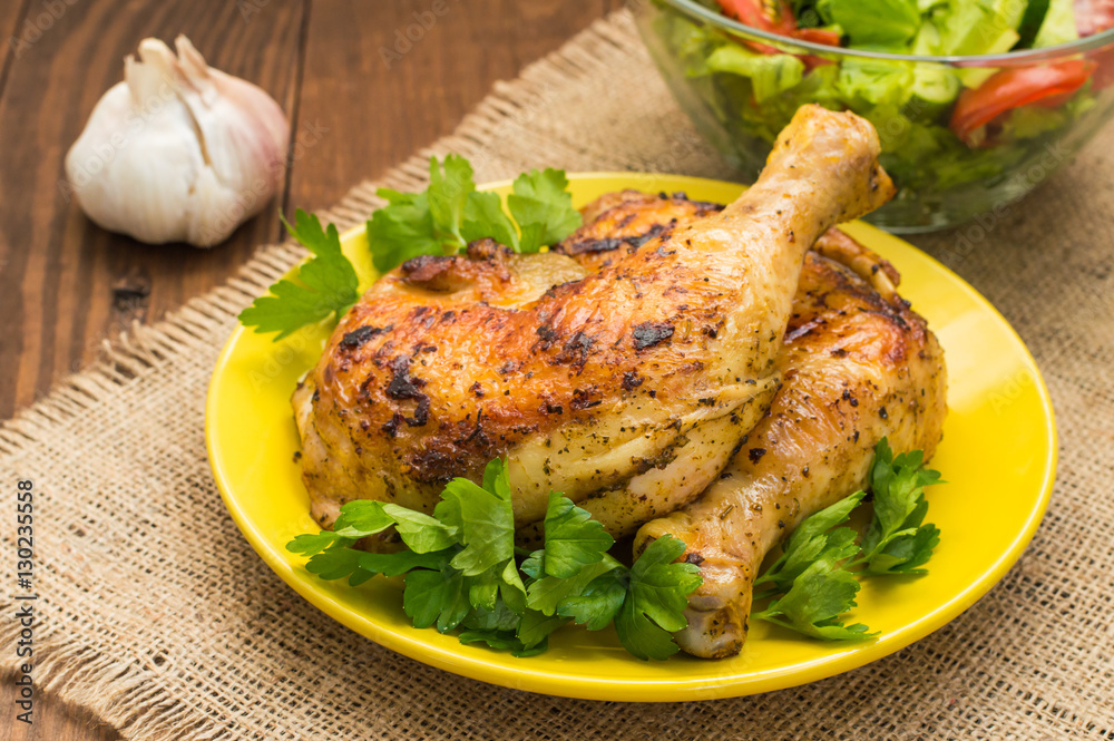 Roasted chicken legs on a wooden background. Top View. Close-up Roasted chicken legs on a wooden background. Top View. Close-up