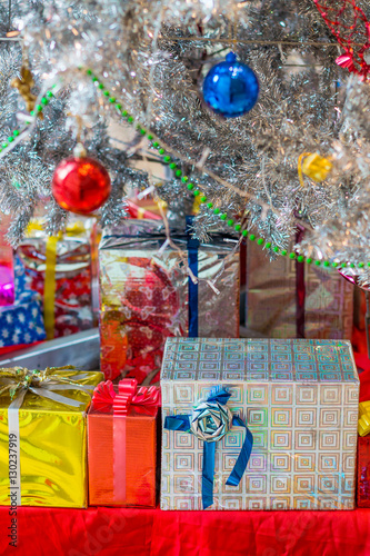 Fototapeta Naklejka Na Ścianę i Meble -  Xmas gift boxes with ribbons. The ornament and decoration under Christmas tree.
