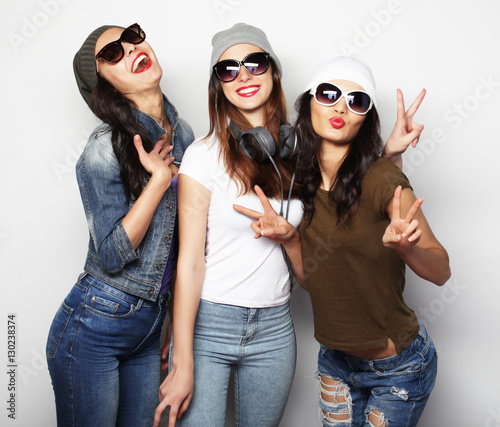 Fashion portrait of three stylish sexy hipster girls best friend