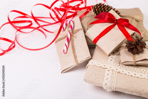 Christmas boxes with gifts tied with ribbon and pine cones isolated on white background