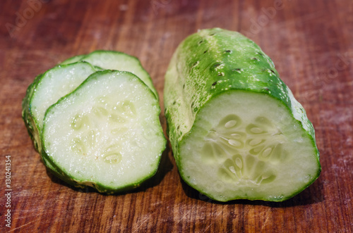 Sliced cucumber on a wooden table photo