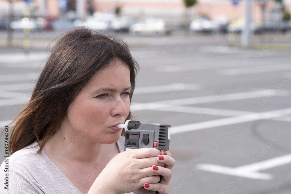 woman examines the level of alcohol woman examines the level of alcohol
