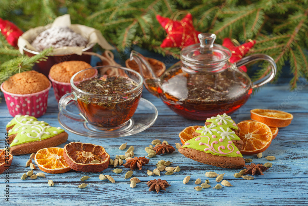 Christmas cup of tea and spices on wooden table