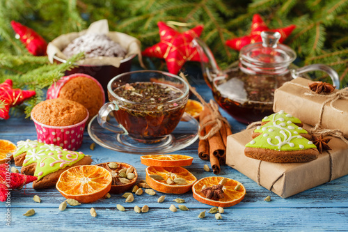 Christmas cup of tea and spices on wooden table