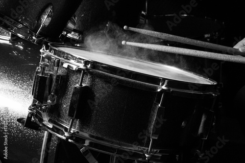 The man is playing drumset