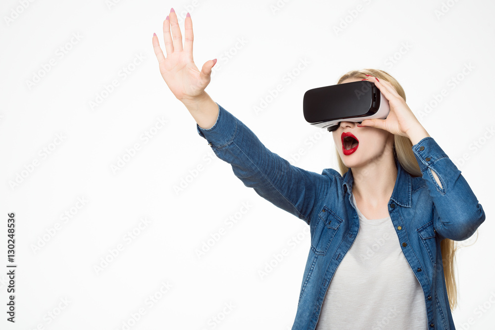 Attractive woman wearing virtual reality glasses. VR headset. Virtual reality concept on white background.