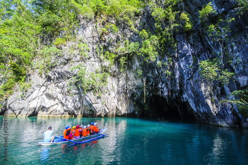 Tourists in a rowing boat entering the Puerto Princesa underground river, the New Wonder of the World, Puerto-Princesa Subterranean River National Park, Palawan, Philippines photo