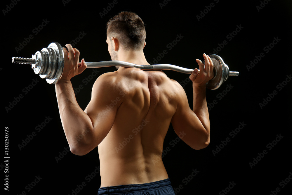 Sporty man doing exercises with barbell on black background Sporty man doing exercises with barbell on black background