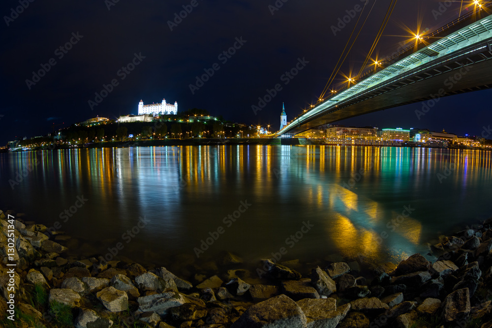 Naklejka premium View of a medieval castle in Bratislava from under the bridge through Danube