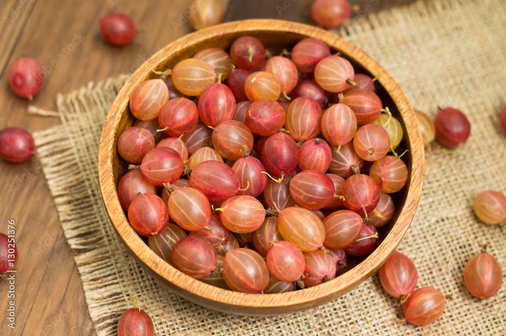 Gooseberries on a wooden background. Top view. Close-up Gooseberries on a wooden background. Top view. Close-up