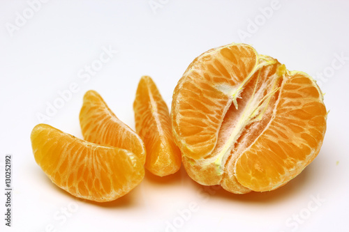 Mandarin  tangerine citrus fruit isolated on white background. Pile of a fresh oranges and several segment of peeled citrus.