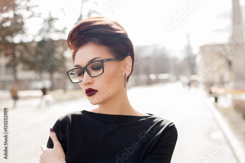 Young stylish woman walking in a city street