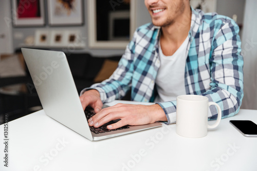 Cropped image of man using laptop computer