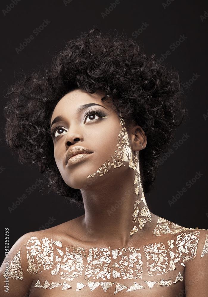 Fototapeta Portrait of African American woman in gold