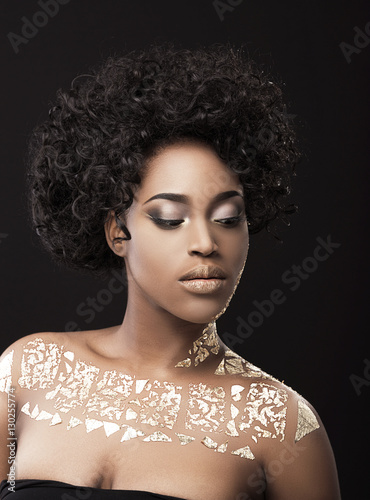 Portrait of Afro-American woman in gold