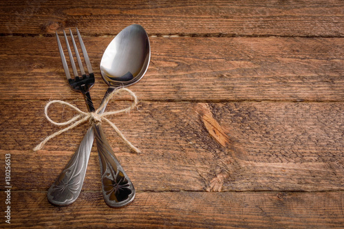 cutlery fork and spoon on a wooden background