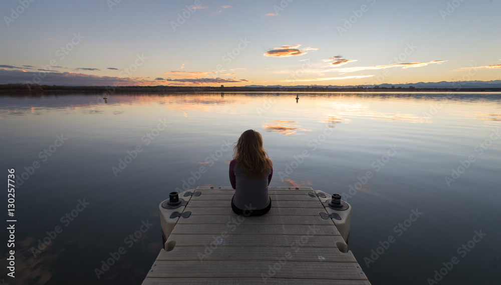 Girl sitting on Dock Sunset