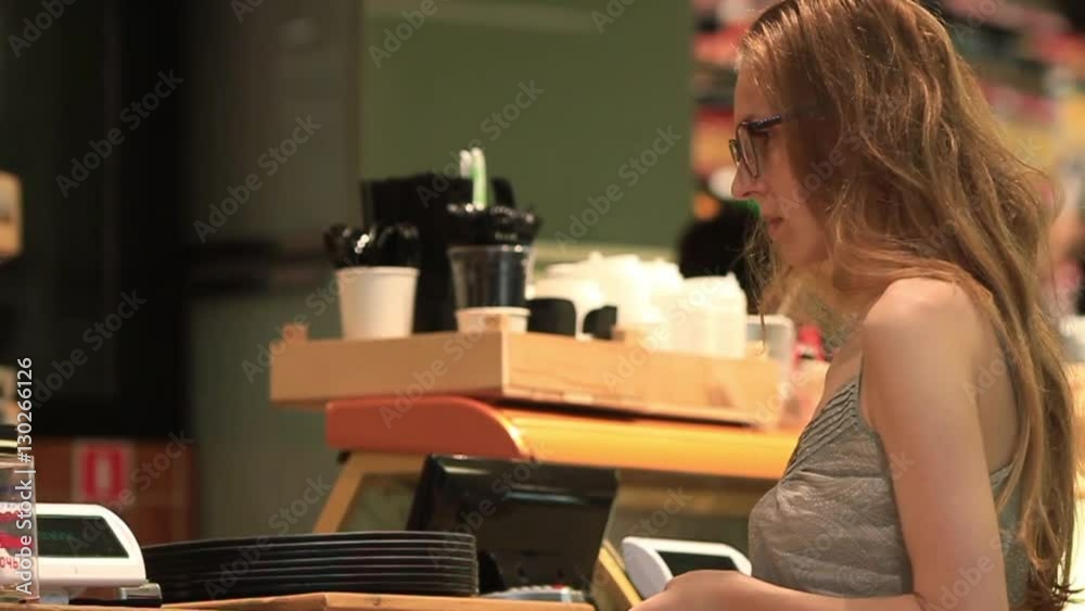 Young woman getting check and change and waiting for the order Young woman getting check and change and waiting for the order