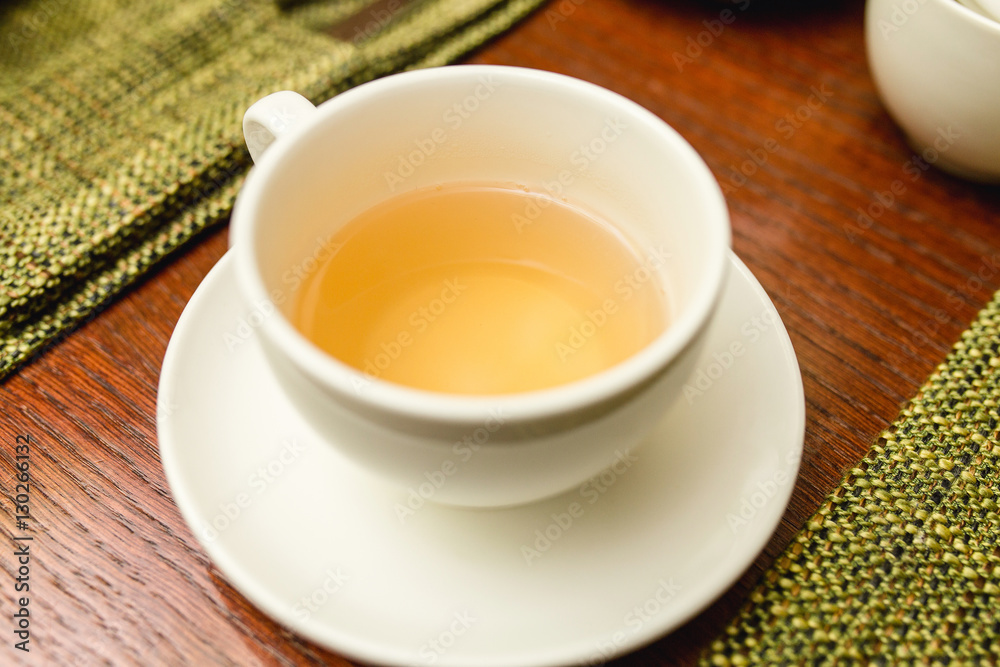 Yellow soft herbal tea in a cup in the restaurant Yellow soft herbal tea in a cup in the restaurant
