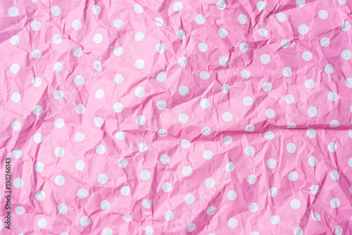 Crumpled pink dotted background or texture
