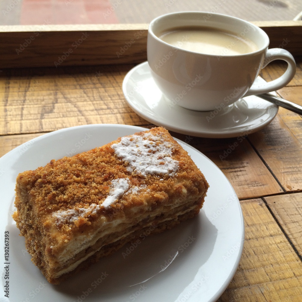 Start your day with homemade Gourmet cake with icing on the wood table with blur boken cup of coffee background Start your day with homemade Gourmet cake with icing on the wood table with blur boken cup of coffee background