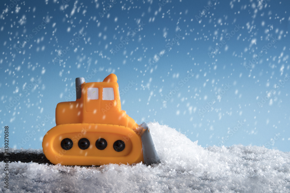 Snow plow. Toy car in a little winter landscape. Concept of road cleaning and road safety. Snow plow. Toy car in a little winter landscape. Concept of road cleaning and road safety.