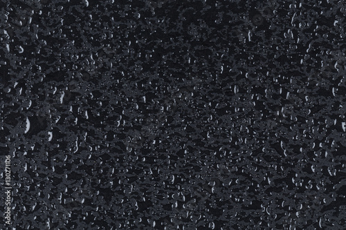 Water drops on dark stone surface