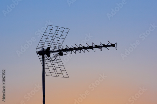 Silhouette of mobile communication antennas at sunset