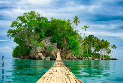 Bamboo hanging bridge over sea to tropical island © 12ee12