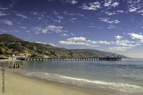 Malibu beach scene with pier, mountains background