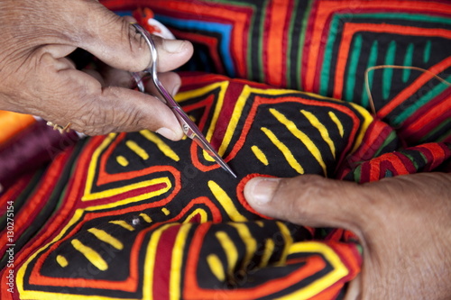 Kuna indigenous woman sewing a mola in the San Blas Islands, Panama photo