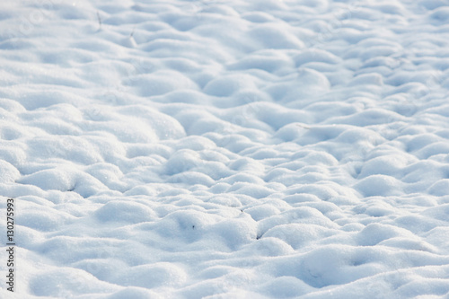 texture of white snow like small drifts that covered the dug earth