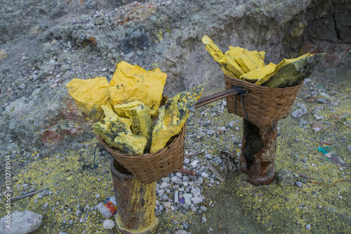 Pieces of sulfur are two wicker baskets connected by a crossbar (Indonesia) photo