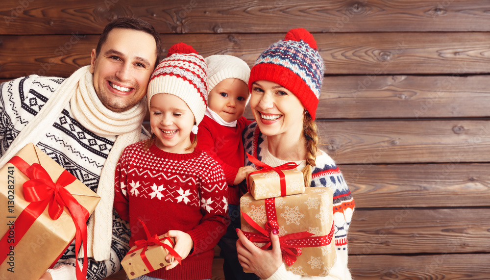 happy family mother, father and children with Christmas gifts on