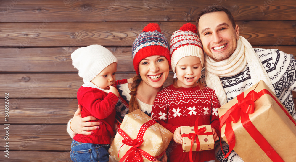 Fototapeta premium happy family mother, father and children with Christmas gifts on