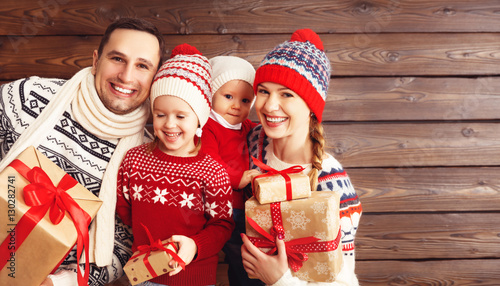 happy family mother, father and children with Christmas gifts on