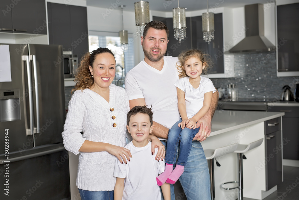 Portrait of a happy family of four in the kitchen at home Portrait of a happy family of four in the kitchen at home